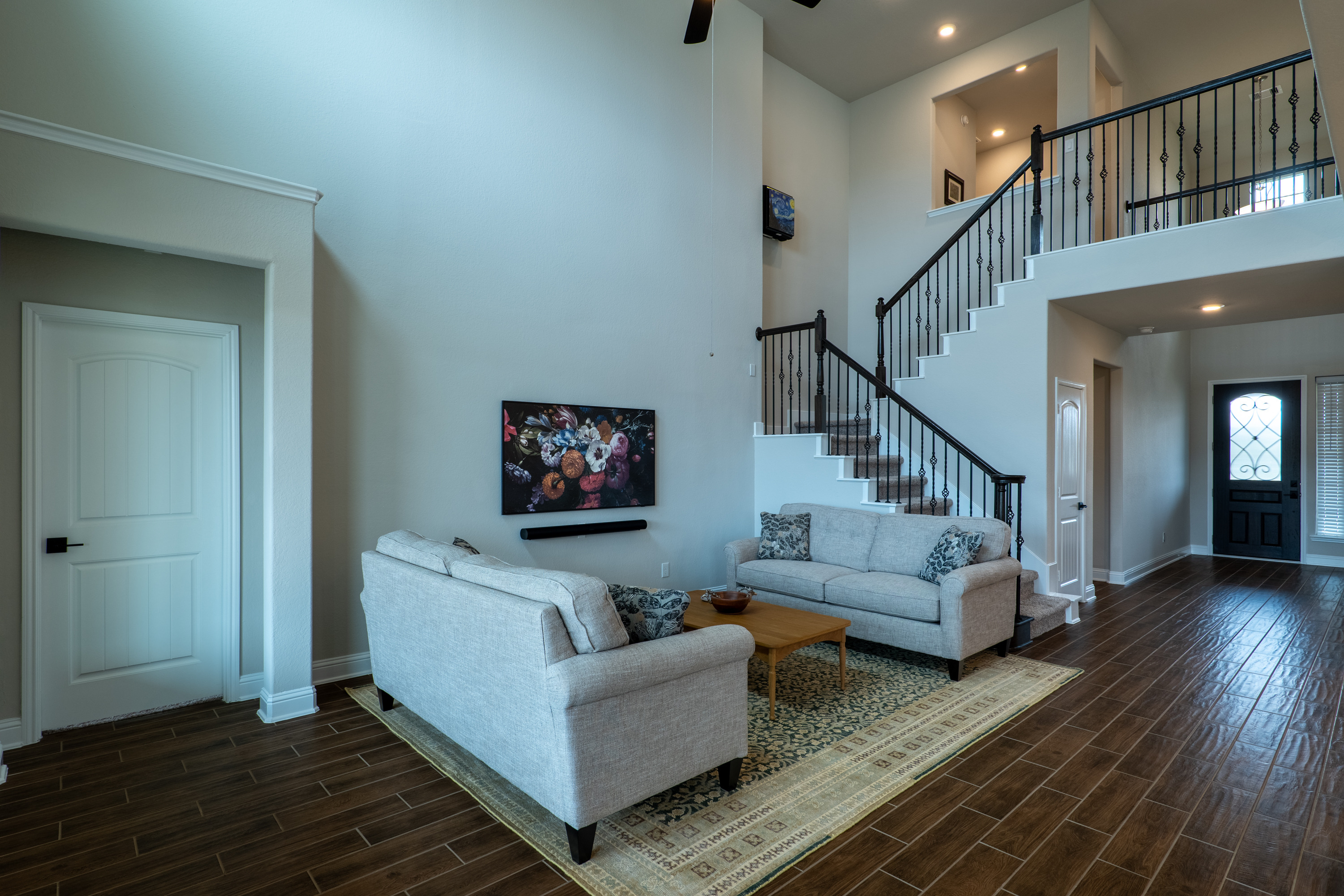 Two-story great room and entry foyer. Daltile Willow Bend wood-look porcelain plank tile runs through the first floor.