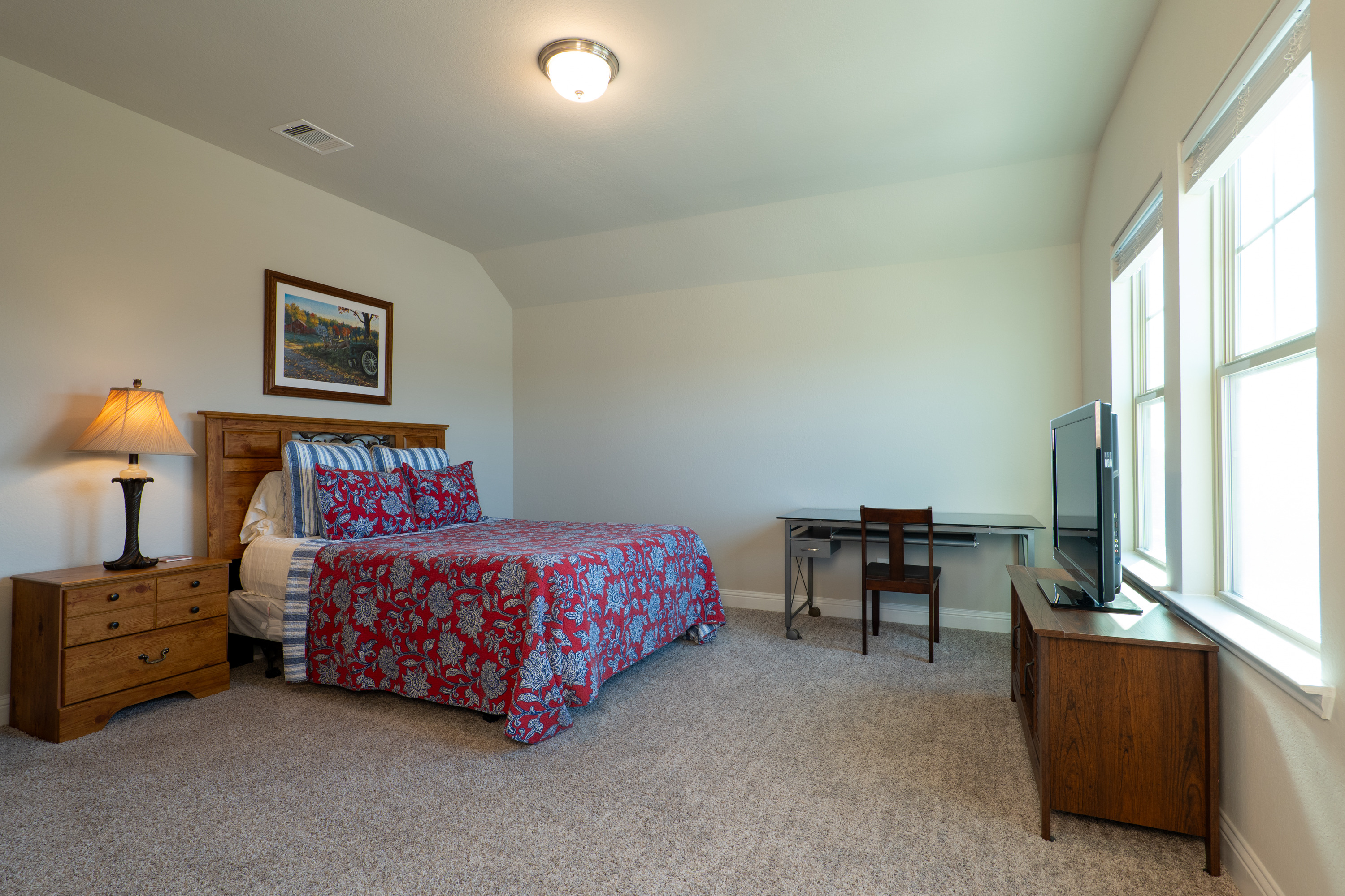Oversized bedroom, approx. 15′ × 14′, with a windowed walk-in closet.