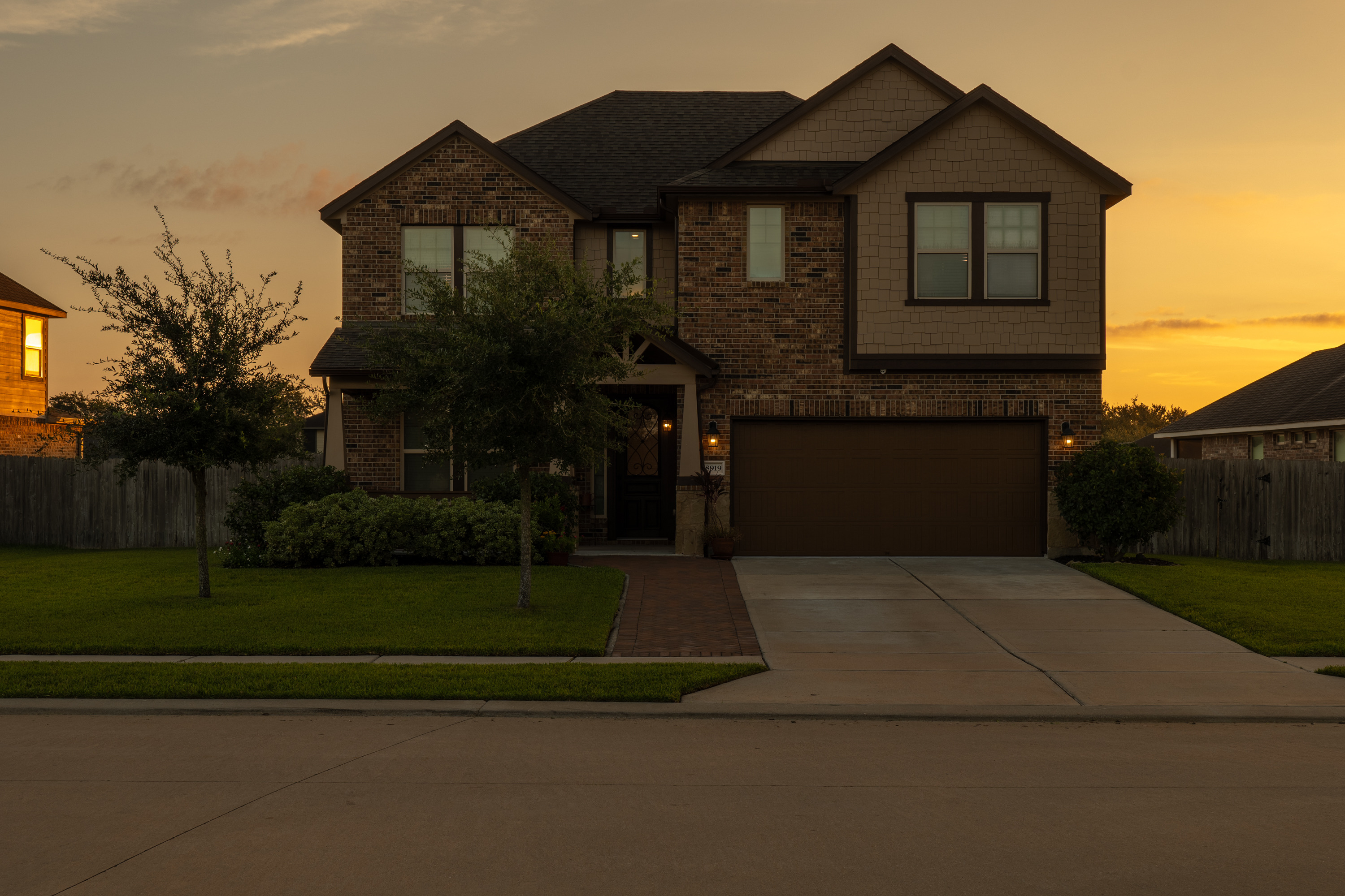 Front elevation in the early morning, with sunrise behind the house.